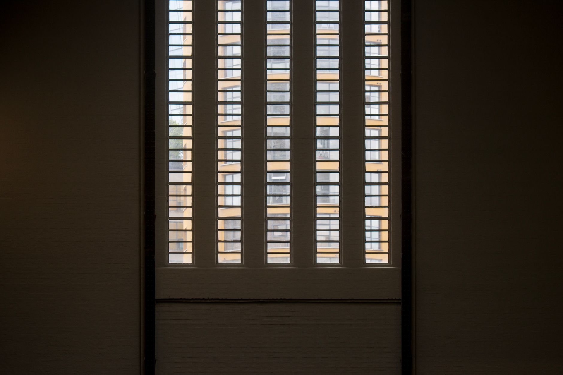 Interior view of plantation shutters allowing light to filter into a room